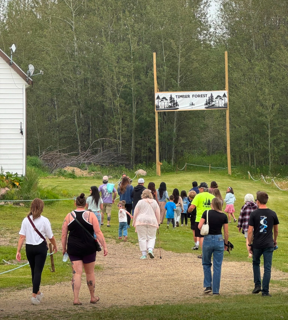 Families and children walking toward the Timber Forest entrance at Timber Festival 2026